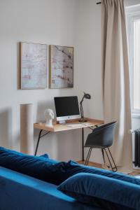 a desk with a computer and a chair in a room at Contemporary Flat in New Town by Prague Days in Prague