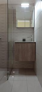 a bathroom with a sink and a glass shower at Aristotelis Apartments in Frikes