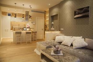 a living room with a couch and a kitchen at Design Suites Palma in Palma de Mallorca