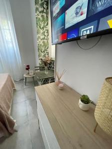 a living room with a flat screen tv on a wall at Casa Luna IV tu oasis en Madrid in Madrid