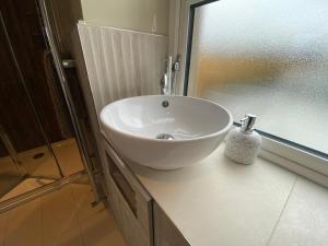 a white sink sitting on top of a counter in a bathroom at NEW - The Gate Lodge at Dunnanew - 4 star- Sleeps 5 in Seaforde