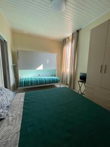 a bedroom with a large green bed in a room at De Sùra - La Terrazza sul Naviglio in Milan