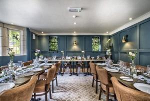 a large dining room with a long table and chairs at The Vines Hotel in Alvescot