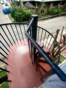 a balcony with a wrought iron railing on a street at Grapevine Garden in Kota Kinabalu