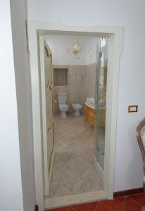 a bathroom with a shower and a toilet and a sink at Palazzo Tilli in Casoli
