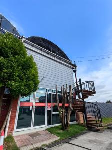 a building with a staircase in front of it at Grapevine Garden in Kota Kinabalu