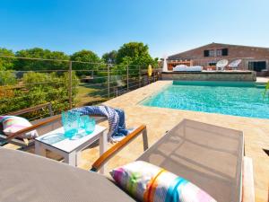 a swimming pool with a table and chairs next to a table at Barcares Petit by BeBreeze Mallorca in Alcudia