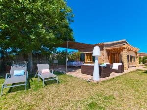 a yard with two chairs and a lamp in front of a house at Barcares Petit by BeBreeze Mallorca in Alcudia +30 photos