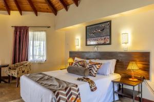 Postel nebo postele na pokoji v ubytování Sentrim Elementaita Lodge
