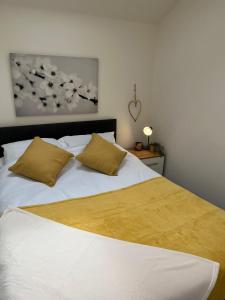 a bedroom with a white bed with two pillows at Bliss Apartments - Contractor 314 in Bradford