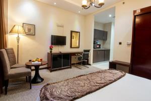 a hotel room with a bed and a living room at Better Living Apartment in Dubai