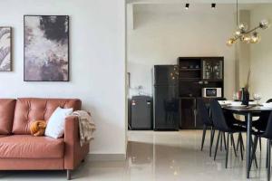 a living room with a brown couch and a table at Spacious Townvilla - 10pax in Puchong