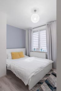 a bedroom with a white bed and a window at Bright Condo in Nusle by Prague Days in Prague