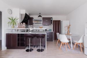 a kitchen with a counter and a table and chairs at Bright Condo in Nusle by Prague Days in Prague