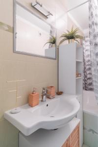 a bathroom with a white sink and a mirror at Bright Condo in Nusle by Prague Days in Prague