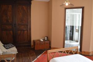 um quarto com uma porta, uma mesa e uma cadeira em DUC MANOIR Chambres d'hôtes em Aubin