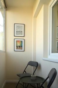 a chair and a table in a room with a window at Apartament Mony in Timişoara