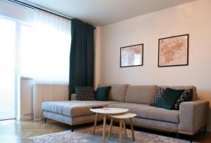 a living room with a couch and a table at Apartament Mony in Timişoara