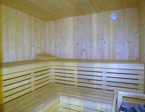 a wooden sauna with a clock on the wall at BG Nautico Ebeso in Ibiza Town