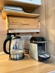a coffee maker and a toaster sitting on a shelf at 2 Bedroom Ski in Ski Out in Bach