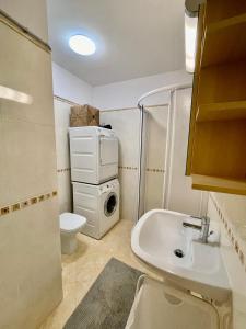 a bathroom with a sink and a washing machine at 2 Bedroom Ski in Ski Out in Bach