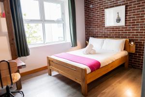 Postel nebo postele na pokoji v ubytování The Nest Boutique Hostel