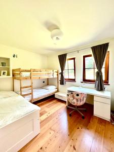 a bedroom with two bunk beds and a desk at 2 Bedroom Ski in Ski Out in Bach