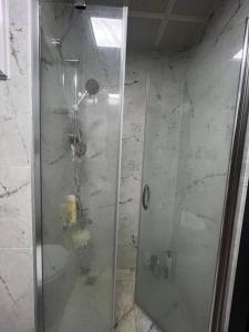a shower with a glass door in a bathroom at Cozy apartment with great features in Antalya