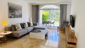 a living room with a couch and a table at Aloha Gardens by Vacation Care in Marbella