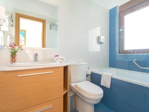 a bathroom with a toilet and a sink and a tub at Holiday home in Kiotari near the beach in Kiotari