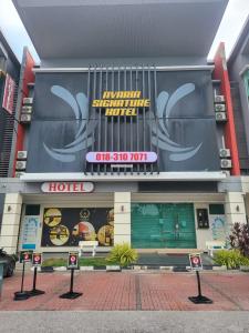 a hotel with a sign on the front of it at Avaria Signature Hotel in Melaka