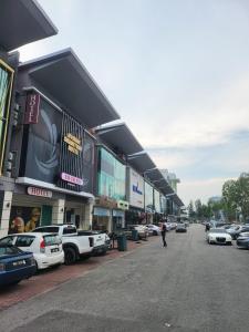 a parking lot with cars parked in front of a building at Avaria Signature Hotel in Melaka