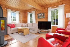 a living room with a couch and a tv at Hytte i flott natur in Alta