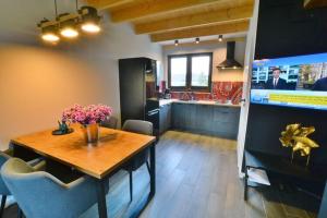 a kitchen with a table and a dining room at Holiday house sauna whirlpool Mielenko in Mielenko