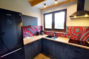 a kitchen with a sink and a window at Holiday house sauna whirlpool Mielenko in Mielenko