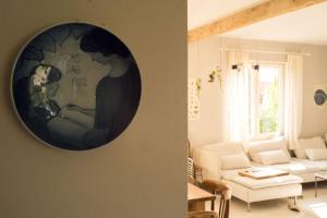 a living room with a couch and a painting on the wall at Podlasie x Magical cottage surrounded by nature in Narew