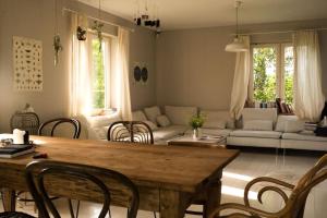 a living room with a table and a couch at Podlasie x Magical cottage surrounded by nature in Narew