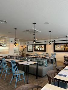 a restaurant with tables and chairs and a couch at Gran Hotel Flamingo-Adults Only older 18 years old in Lloret de Mar