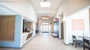 a hallway of a hospital with a table and chairs at Holiday Inn Express Oakdale, an IHG Hotel in Oakdale