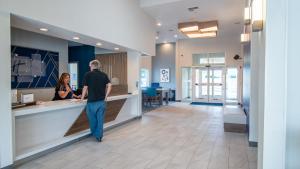 a man and a woman standing at a counter at Holiday Inn Express Oakdale by IHG in Oakdale +56 photos