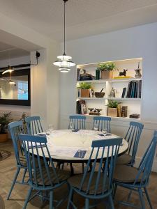 a dining room with a table and blue chairs at Gran Hotel Flamingo-Adults Only older 18 years old in Lloret de Mar