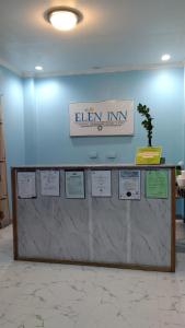 a counter with a sign on a wall at ELEN INN - Malapascua Island FAN ROOM #2 in Malapascua Island