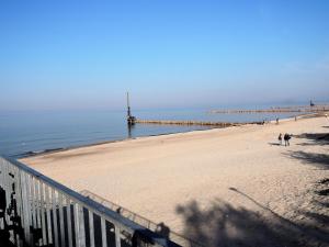 a beach with a pier in the water at Pretty bungalow in Wrzosowo with garden in Wrzosowo