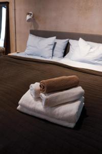 a pile of towels sitting on top of a bed at Sångbergs Hotell in Tranemo