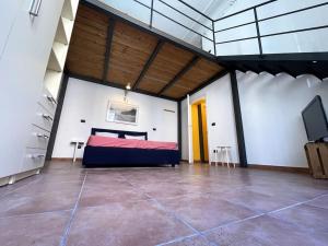 a large room with a bed and a tv in it at Loft storico in pieno centro! in Livorno