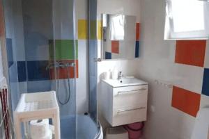 a colorful bathroom with a sink and a shower at Leisure complex with a swimming pool Jezierzany in Jezierzany