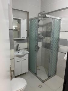 a bathroom with a shower and a toilet and a sink at Nobel Boutique Hotel in Selçuk