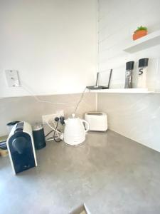 a kitchen counter with a tea kettle and a blender at Charming Beach Home in Mornington