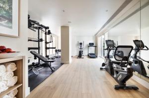 a gym with treadmills and elliptical machines at One Shot Palácio Cedofeita in Porto