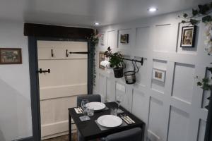 a dining room with a table with two plates on it at The Old Pantry at Hill Farm in Penley